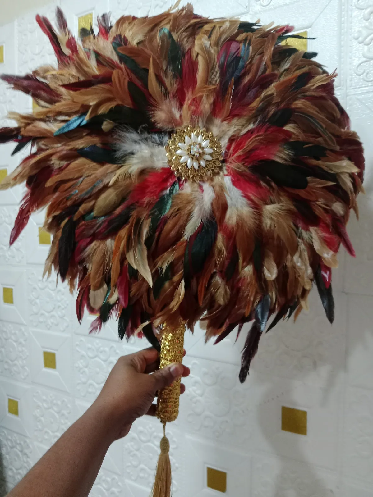 Rust and copper feather hand fan with beaded centre