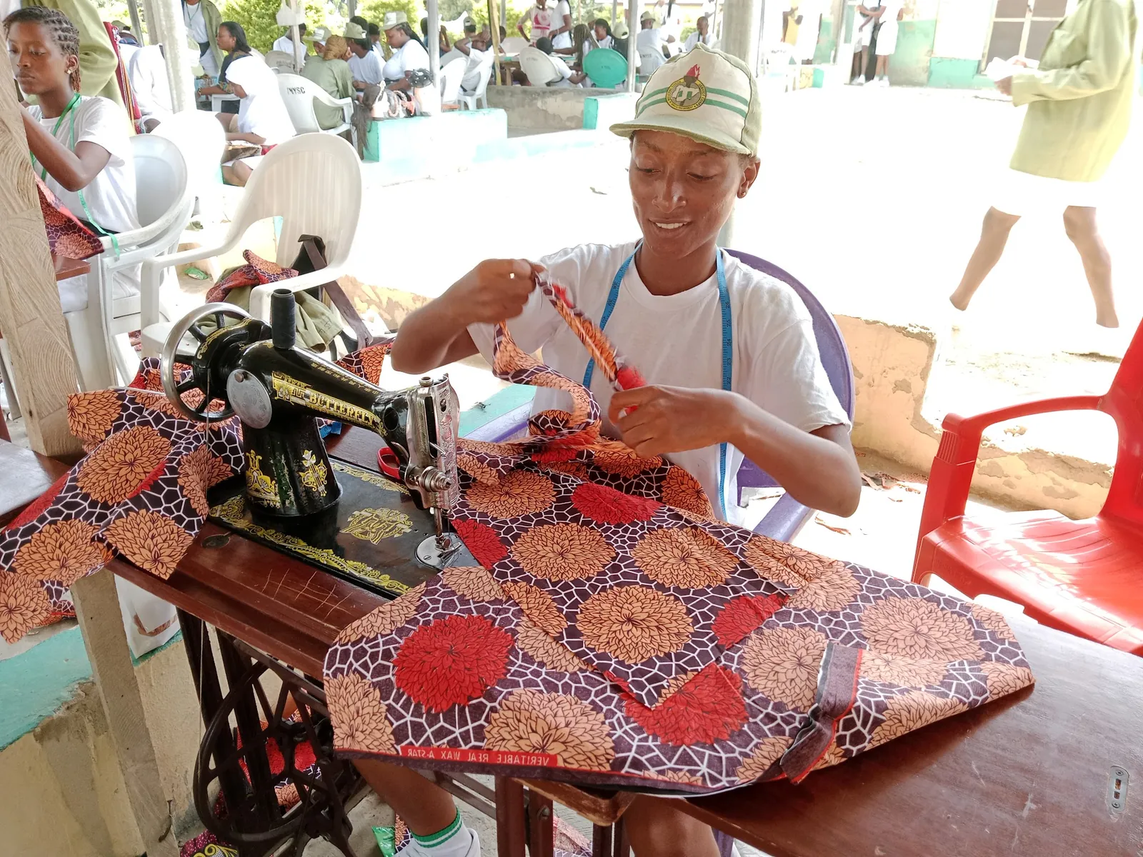 Trainee sewing Ankara on a treadle machine