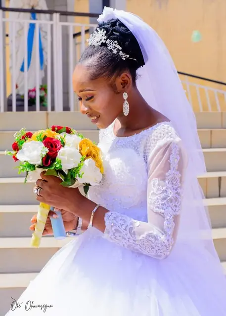 Bride with a red and yellow rose bouquet