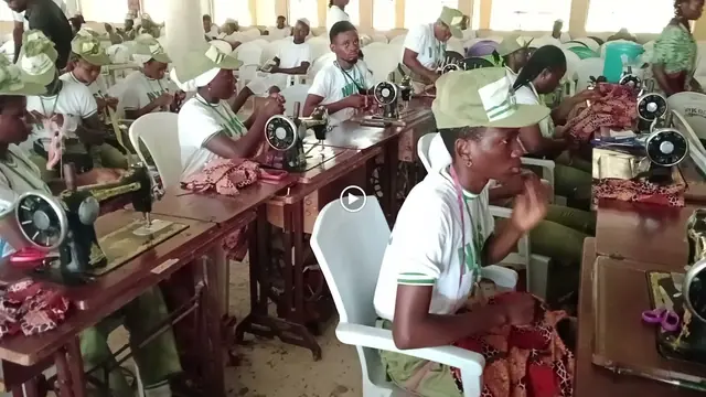 Corps members at sewing machines