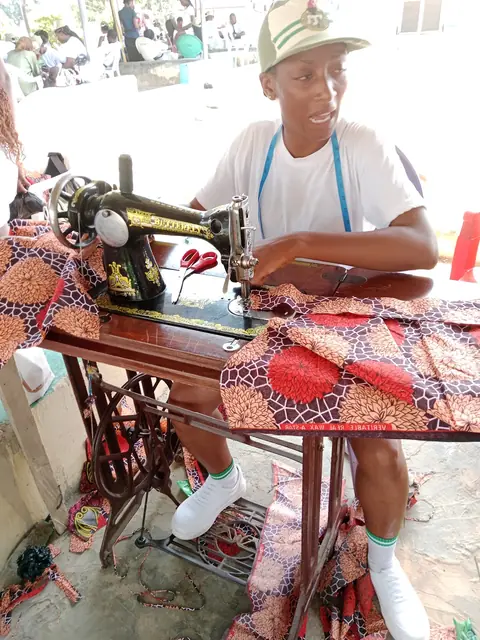 Trainee at a treadle sewing machine