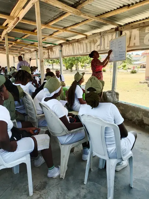 Corps members listening at a tailoring session